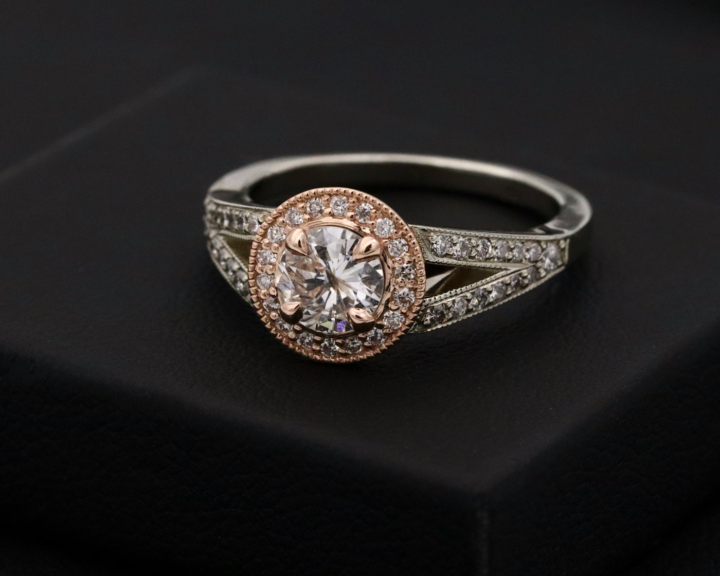 Round brilliant diamond ring with a rose gold halo setting